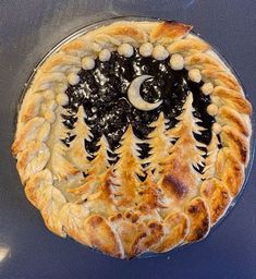 a pie with pine trees and moon on it