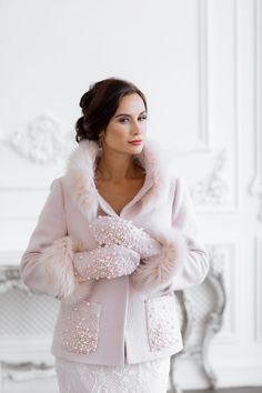 Introducing our exquisite Bridal Coat, Bridal Jacket for Winter Wedding Dress! This remarkable piece is designed to add a touch of elegance and warmth to your special day. Crafted with meticulous attention to detail, this versatile jacket is perfect for brides seeking both style and practicality. Whether you envision a casual affair or a grand formal occasion, our bridal coat is here to complement your winter wedding dress effortlessly, leaving you feeling cozy and confident on your big day. - Wool Boucle Bridal Coat: This coat is made from luxurious wool boucle fabric, providing utmost comfort and ensuring a sleek silhouette. - Pink Delight: A subtle blush pink shade adds a romantic and feminine touch to this bridal jacket, allowing you to stand out from the crowd. - Embroidered with Pear Elegant Embroidered Wedding Outerwear, Cream Winter Wedding Outerwear, Elegant Fitted Outerwear For Reception, Pearl Embroidered Long Sleeve Wedding Outerwear, Wedding Long Sleeve Outerwear With Embroidery, Wedding Outerwear With Embroidery And Long Sleeves, Wedding Outerwear With Embroidered Long Sleeve, Embroidered Cream Outerwear For Wedding, Embroidered Long Sleeve Outerwear For Wedding