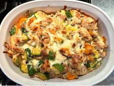 a casserole dish with meat, vegetables and cheese