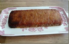 a large piece of meat on a pink and white plate