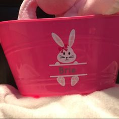 a pink bucket with a bunny on it sitting in the back seat of a car