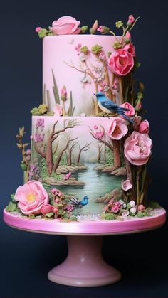 a three tiered cake decorated with pink flowers and birds on a table next to a blue background