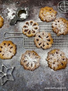 several cookies on a cooling rack and some cookie cutters