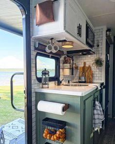 a kitchen area with a sink, stove and oven inside of a camper trailer