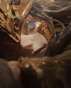 a woman's face is covered in gold and blue eyes, with her hair blowing back to the side