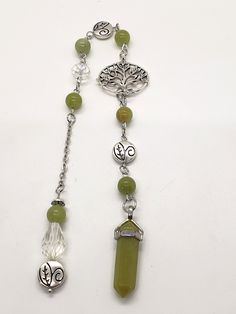 a long necklace with green beads and charms