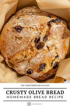 the mediterranean dish crusty olive bread is in a brown paper bag with text overlay that reads, the mediterranean dish crusty olive bread homemade bread recipe