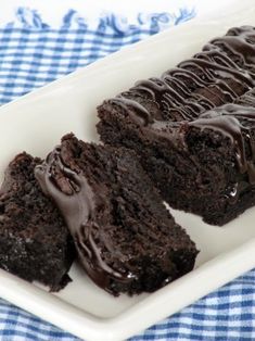 two pieces of chocolate cake on a white plate