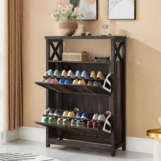 the shoe rack is holding many pairs of shoes and has two shelves on each side