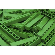 a pile of green lego blocks sitting on top of each other