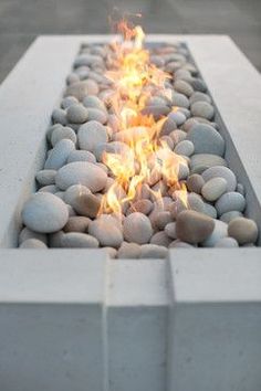 a fire pit is shown with rocks and water in the center, as well as stones on both sides