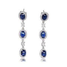 These hanging earrings are handcrafted in 18k white gold and feature three cabochon cut sapphires on each earring. The sapphires are surrounded by halos of round brilliant diamonds. Between the sapphires are small princess cut diamonds. The total weight of the sapphires is 7.70 carats, while the diamonds weigh 1.22 carats combined. The earring backs are push-backs.
The approximate dimensions of each sapphire are 6.66mm x 4.59mm x 2.91mm. The length of these earrings is approximately 4.5cm.
If you have any questions about the Concord earrings, please feel free to contact us. Diamond Hanging Earrings, Estate Diamond Jewelry, Wedding Jewelry Earrings, Hanging Earrings, Perfect Engagement Ring, Accessories Jewelry Earrings, Natural Sapphire, Princess Cut Diamonds, Sapphire Gemstone