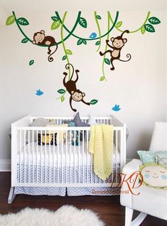 a baby's room with monkeys hanging from the branches