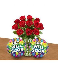 two roses in a vase with balloons and an egg for someone to get well soon