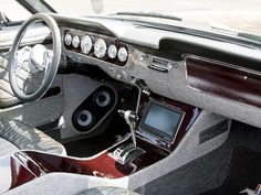 the interior of a car with speakers and dashboard