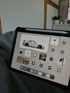 the tablet is displaying photos and icons on it's display screen as well as an image of a car