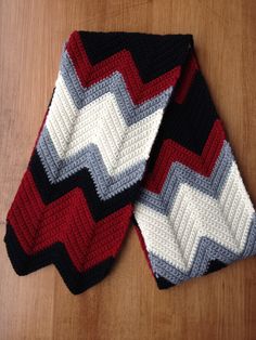 two crocheted ties sitting on top of a wooden table