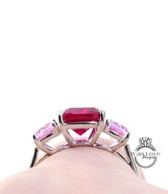 Cushion cut engagement ring vintage Ruby Pink Sapphire engagement ring women Art deco Three stone Alternative Round wedding Anniversary gift Makes the perfect Anniversary gift, Wedding gift, Mothers Day gift, Birthday gift, Holiday gift or just to say I Love You gift!! ~Ring Details~ Metal-925 Silver Dipped in Rhodium (in the Platinum family) Size-6.5 (Can be resized-Silver for $35, Gold for $50 sizing down, ask for sizing up price. **Please ask for a Custom Listing Prior to purchase. Resizing may take approx a week) ~Center Gem~ Type-Ruby (Lab grown, same properties as natural) Weight-2.5-3ct (approx) Size-8mm Color-Red Clarity-VVS Cut (shape)-Cushion ~Accent Gems~ Type-Sapphires (Lab grown, same properties as natural) Weight-.50-.75cteax2=1-1.5ct (approx) Size-5mm Color-Pink Clarity-VVS Princess Cut Jewelry With Side Stones As Gift, Princess Cut Jewelry With Side Stones For Gift, Fine Jewelry Rings With Side Stones As Gift, Promise Ring With Asscher Cut And Accent Stones, Anniversary Rings With Princess Cut Side Stones, Anniversary Princess Cut Rings With Side Stones, Radiant Cut Birthstone Ring With Center Stone For Weddings, Asscher Cut Promise Ring With Accent Stones, Princess Cut Rings With Side Stones For Anniversary