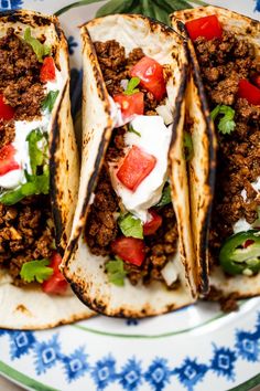 three tacos on a plate with the text, the best ground venison tacos