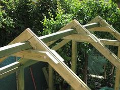 the roof is being built for this chicken coop