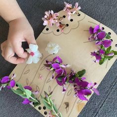 a child is cutting flowers on a piece of paper