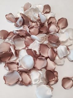 some pink and white petals on a white surface