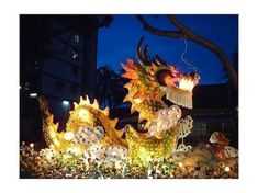 an elaborately decorated dragon is lit up at night