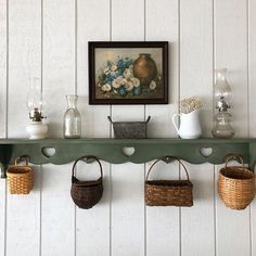 a shelf with baskets and vases on it