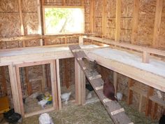 the inside of a chicken coop that is being built with wood and insulation in place