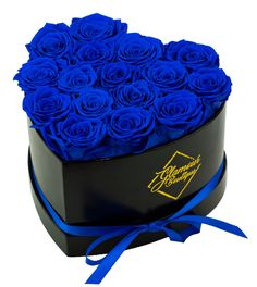 a heart shaped box filled with blue roses