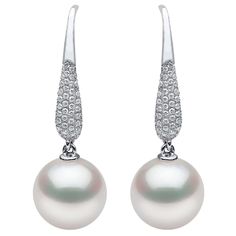 These elegant earrings by Yoko London feature lustrous Freshwater pearls beneath scintillating pavé diamonds. Expertly handcrafted in our London atelier, these delicate earrings have been designed to the highest standard. Classic and sophisticated, these earrings will add a touch of elegance to any outfit. - 11-12mm Freshwater Pearls - 0.53cts of Diamonds - 18K White Gold - Hook Fitting - Certificate of Authenticity Elegant Pave Setting Diamond Earrings For Formal Occasions, Elegant Formal Diamond Earrings With Pave Setting, Elegant Evening Diamond Earrings With Pave Setting, Elegant Diamond Earrings With Pave Setting For Evening, Luxury Pearl Earrings With Pave Setting For Formal Occasions, Exquisite White Pave Setting Earrings, Exquisite White Earrings With Pave Setting, Formal Fine Jewelry Pearl Earrings With Pave Setting, Formal Pearl Earrings With Pave Setting