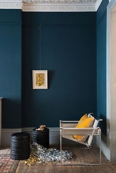 a living room with blue walls and wooden floors