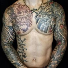 a shirtless man with tattoos on his chest