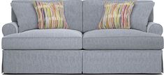 a gray couch with two pillows on it's back and the arms facing each other