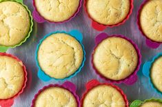 twelve muffins in colorful cupcake pans lined up