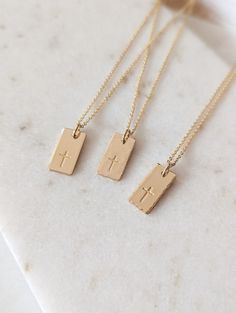 "Dainty cross necklace, 14k Gold Fill, Sterling Silver, Minimalist necklace, Cross gift, Rectangle tag, Religious, Gift for her, Faith necklace, Christian gift, Baptism gift for her, Mothers Day Gift This beautiful cross tag necklace is the perfect piece to wear everyday. PLEASE NOTE: I do not offer back stamping on any item in my shop! D E T A I L S * Gold Filled: Gold Filled Disc, Clasp and Chain. * Sterling: .925 Sterling Silver Disc, Clasp and Chain. P E N D A N T * Size: approx. 5/8\" x 5/1 Dainty Christian Jewelry, Simple Christian Jewelry, Gold Christian Jewelry, Minimalist Crucifix Charm Necklace As Gift, Gold Personalized Minimalist Cross Necklace, Gold Minimalist Personalized Cross Necklace, Minimalist Personalized Gold Cross Necklace, 14k Gold Filled Cross Pendant Necklace As Gift, 14k Gold Filled Cross Necklace Gift