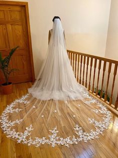 a wedding veil with flowers on the floor