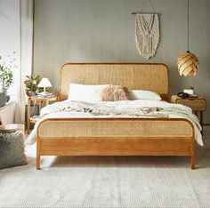 a bed sitting in a bedroom next to two tables with lamps on top of them