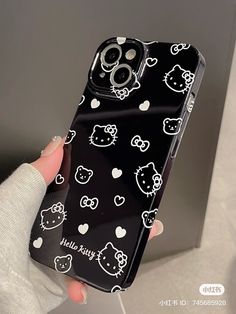 someone is holding up their phone case with hello kitty designs on the front and back