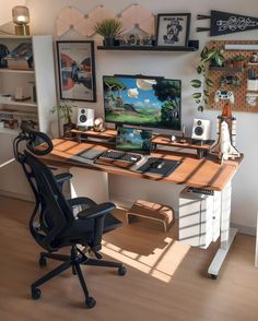 a desk with a computer on it in front of a wall full of pictures and plants