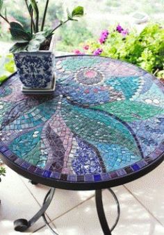 a mosaic table with a potted plant on top