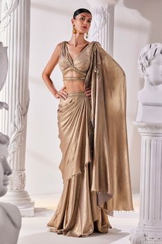 Metallic antique gold pre-draped saree. Paired with a luxurious metallic embroidered blouse with a cutout and tassel details and an embroidered tasseled belt. - Aza Fashions Elegant Pre-draped Saree For Festivals, Gold Pre-draped Saree For Reception And Festive Occasions, Fitted Gold Pre-draped Saree For Festive Occasions, Elegant Draped Sharara With Cutdana, Gold Pre-draped Saree With Cutdana In Traditional Drape, Elegant Draped Cutdana Sharara, Elegant Gold Pre-draped Saree For Festivals, Elegant Draped Lehenga With Dupatta, Elegant Draped Sharara For Receptions