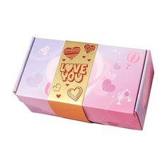 a pink box with gold foil on the top and hearts around it that says i love you