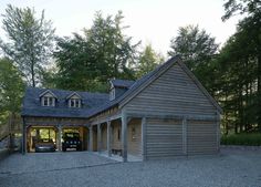 an image of a garage in the middle of a driveway with two cars parked inside