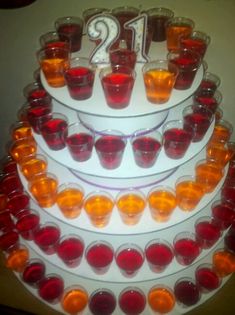 a tiered cake with orange and red glasses on it's side, decorated with the number twenty