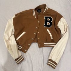 New With Tag Cheap Winter Varsity Jacket With Button Closure, Trendy Brown Varsity Jacket For Winter, Brown Varsity Outerwear For Fall, Trendy Brown Varsity Jacket For College, Trendy Brown Long Sleeve Varsity Jacket, Sporty Brown Spring Outerwear, Sporty Brown Outerwear For Spring, Brown Fluffy Jacket, Cropped Baseball Jacket