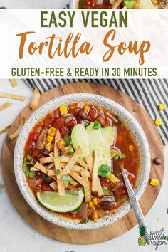 a bowl of tortilla soup on top of a wooden cutting board