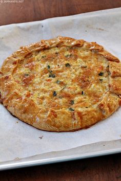 a pizza sitting on top of a white paper