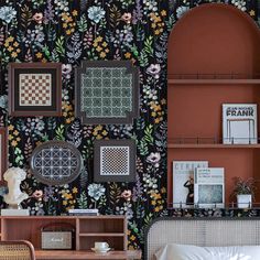 a bedroom with floral wallpaper and wooden shelves on the wall next to a bed