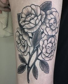 a black and white flower tattoo on the leg